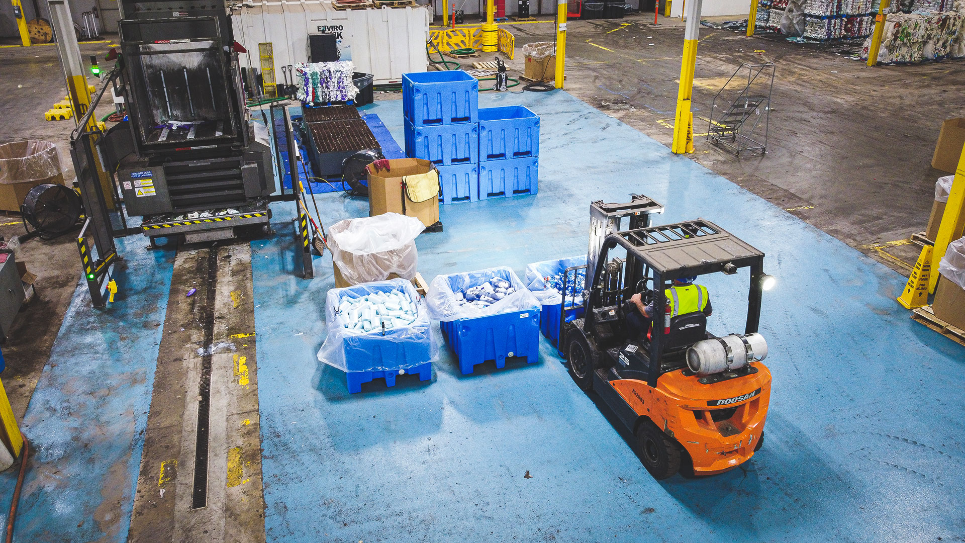 Bins of plastics waiting to be compressed and baled