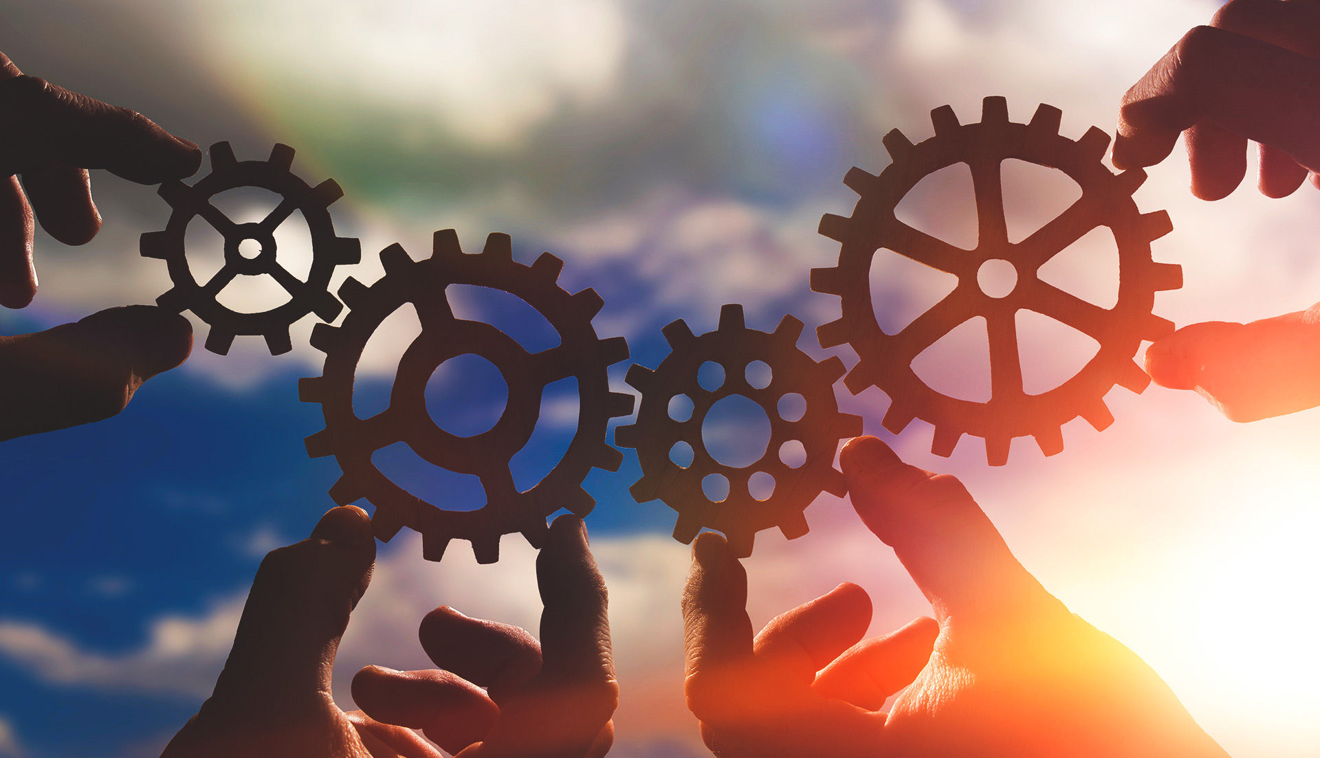 hands holding gears for innovation, total waste management