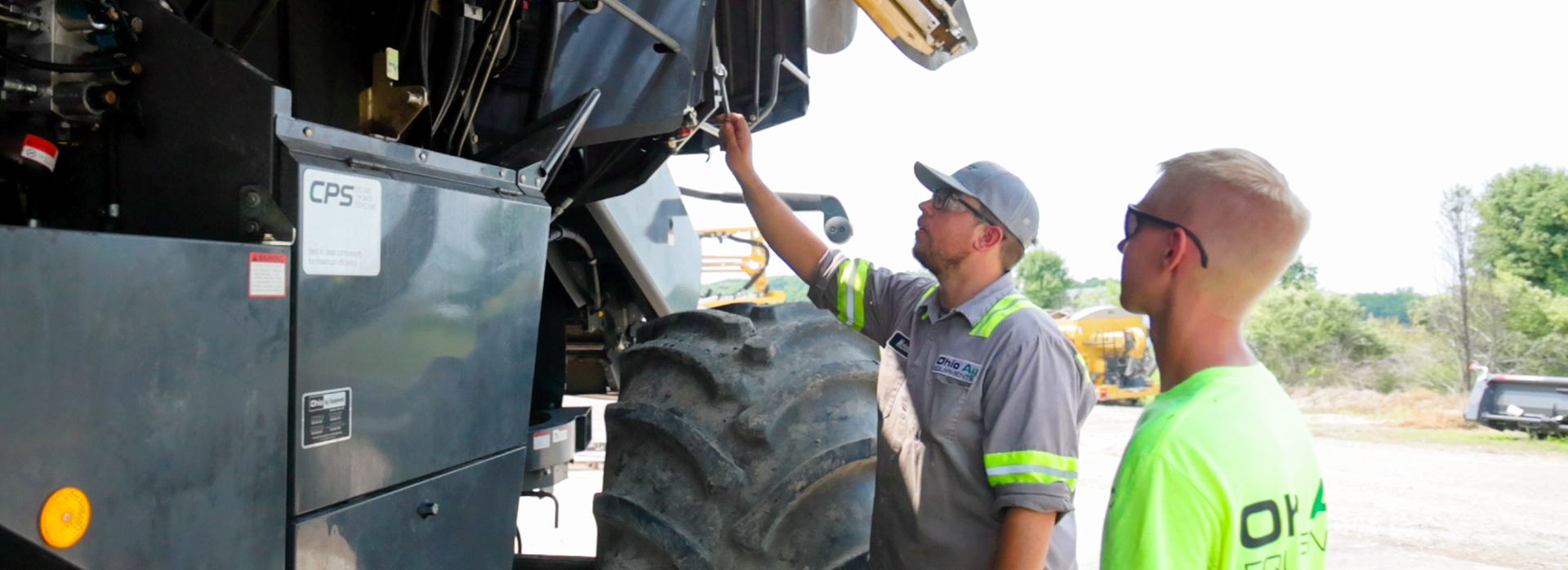 mechanics looking at heavy machine