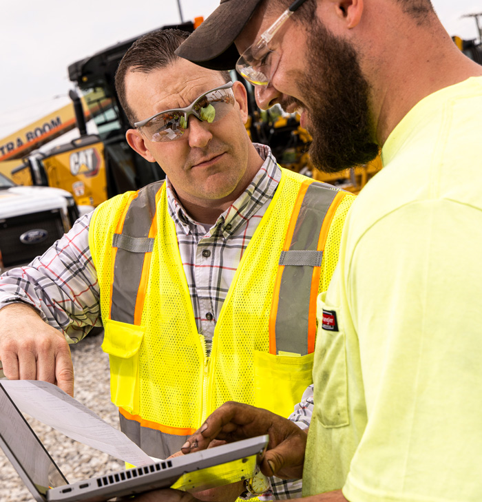 mechanics looking at laptop