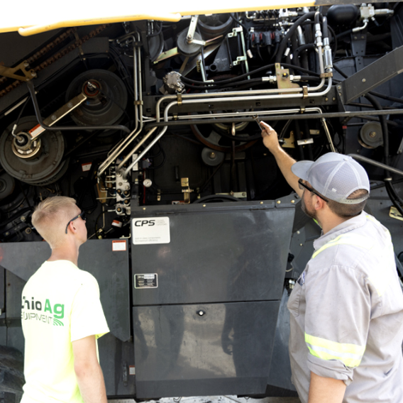 mechanics pointing to specific machine parts