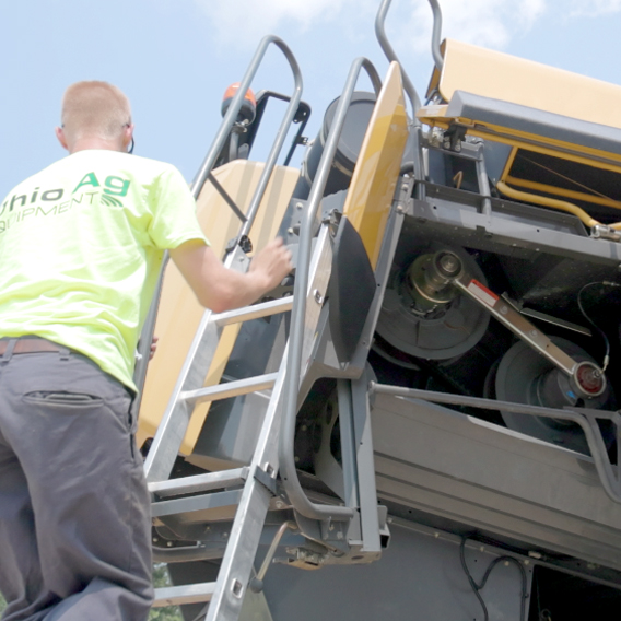 ohio ag worker climbing up machine